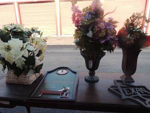 lot 28 image: 2 metal flower vases with arrangement   white wicker basket with arrangement   18x20 Willard wall clock   metal 12x12 symbol wall art