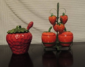 lot 98 image: Strawberry sugar dish with cover and spoon and Matching Condiment  set on stand S&P shakers and sugar