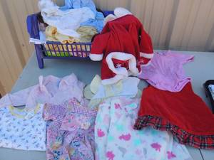 lot 268 image: Blue basket full of baby doll clothing