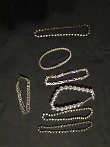 lot 356 image: Bracelets- silver beaded, small rhinestones 6, silver chain with green and clear stones, bronze with clear stones 9 x 2 and pink ribbon with pink stone (breast cancer awareness)