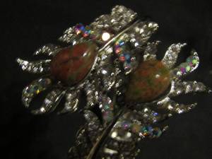 lot 397 image: Clasp cuff bracelets- silver jewel palm leaves with black center and same with brown center