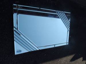 lot 156 image: Metal wall mirror  framing between glass one corner is bent 43x27
