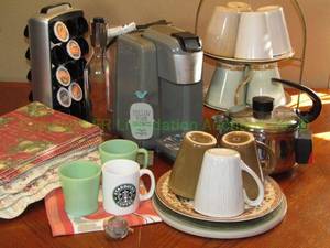 lot 18 image: Wolfgang Puck single serve coffee maker and assorted coffee accessories as shown