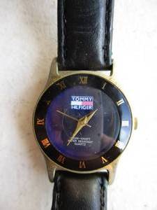 lot 69 image: USED Ladies-Tommy Hilfiger Watch, Black Face with Roman Numerals and second hand.
