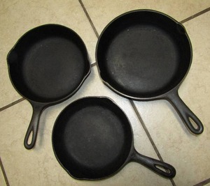 lot 22 image: Lodge and Wagner Ware cast iron pans