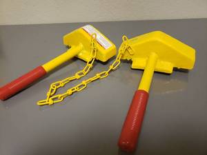 lot 409 image: 2-SINGLE RAIL CHOCKS CONNECTED WITH CHAIN, COLOR SAFETY YELLOW, WEIGHS 16#sPAIR