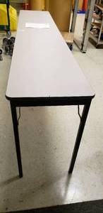 lot 138 image: FOLDING TABLE 18Wx96L, 34 FLAKE BOARD TOP FEATURES HIGH PRESSURE LAMINATE, GRAY NEBULABLACK