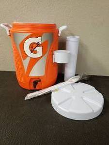 lot 396 image: 5 GALLON GARTORAGE COOLER WITH FAST POURING SPOUT, INCLUDES 12 OZ CUP DISPENSER AND STIRER SET