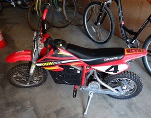 lot 17 image: Razor MX500 Dirt Rocket 36V Electric Toy Dirt Bike with Protective Gear, Red (original Retail $939.00)