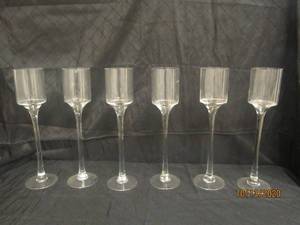 lot 747 image: TOTAL OF 6 STEMMED GLASS CANDLEVOTIVE HOLDER&nbsp 18 H&nbsp&nbsp FEATURES A TIMELESS CYLINDER SHAPE ATOP A LONG STEM AND A CIRCULAR BASE