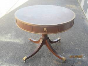 lot 763 image: 36 DIAMETER ANTIQUE DRUM 4-LEGGED TABLE ON WHEELS WITH 4 -DRAWERS, LION FACE DRAWER PULLS&nbsp
