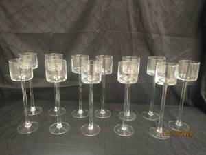 lot 834 image: TOTAL OF 12 STEMMED GLASS CANDLEVOTIVE HOLDER&nbsp 13 H&nbsp&nbsp FEATURES A TIMELESS CYLINDER SHAPE ATOP A LONG STEM AND A CIRCULAR BASE