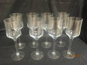 lot 861 image: TOTAL OF 8 STEMMED GLASS CANDLEVOTIVE HOLDER&nbsp 14 H&nbsp&nbsp FEATURES A TIMELESS CYLINDER SHAPE ATOP A LONG STEM AND A CIRCULAR BASE
