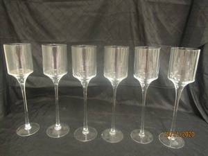 lot 905 image: TOTAL OF 6 STEMMED GLASS CANDLEVOTIVE HOLDER&nbsp 17 12 &nbsp H&nbsp&nbsp FEATURES A TIMELESS CYLINDER SHAPE ATOP A LONG STEM AND A CIRCULAR BASE