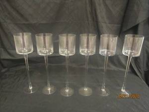 lot 901 image: TOTAL OF 6 STEMMED GLASS CANDLEVOTIVE HOLDER&nbsp 16 H&nbsp&nbsp FEATURES A TIMELESS CYLINDER SHAPE ATOP A LONG STEM AND A CIRCULAR BASE