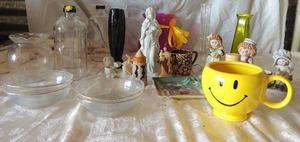 lot 48 image: Glass Bowls,  8 bud vases, Mary statue 2 stein, pottery ashtray, smiley face coffee cup,  3 capped glass bottles 10 black vase and more