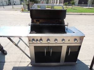 lot 5 image: Master Forge propane grill  Silver and black with 3 doors 51 w 22d 49 h