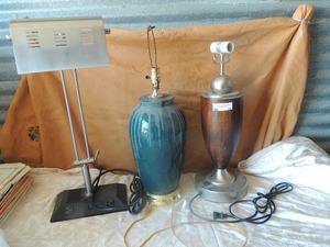 lot 14 image: 3 assorted lamps no shades, 1 black and silver lamp 2 extra plugs stands 25 tall, green lamp 26 brown and silver lamp 23 has plug on top