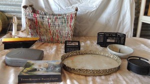 lot 54 image: Blessing note cards, rubber drink coasters,  yellow boat,  glass tray 13x9 ,  black metal-  pen holder for desk,  17x12x8 large wicker basket with old newspaper