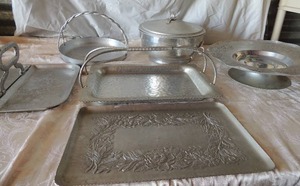 lot 64 image: Aluminum kitchen set-  fold up double sided serving tray, Everlast forged aluminum cake plate  107, hammered covered pot aluminum cookie sheet