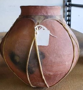 lot 3 image: Possibly Native American Clay Pot with Animal hide Straps