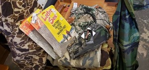 lot 134 image: Hunting Lot including battery heated socks, camo T-shirt, Belt pack, shorts, poncho, pants and jacket
