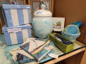 lot 672 image: SAILBOAT PHOTO BOOKS, NAUTICAL THEMED STORAGE BOXES, CANDLE JAR, DECOR AND MORE AS SHOWN.