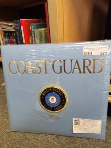 lot 673 image: LIGHT BLUE PHOTO ALBUM WITH UNITED STATES COAST GUARD EMBLEM  SEAL WITH ORIGINAL PACKAGING AS SHOWN. 13.5 X 12.5.