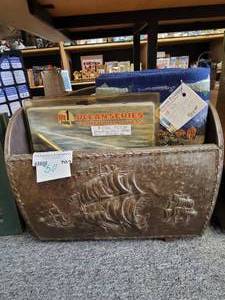 lot 702 image: EMBOSSED BRASS MAGAZINE HOLDER WITH TAPESTRY PLACEMATS, STAINLESS STEEL HITCH COVER AS SHOWN.