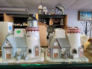 lot 712 image: LOT OF 2 CERAMIC WINTERY LIGHTHOUSE SCULPTURES FOR TEALIGHTS IN STYLESCOLORS SHOWN.