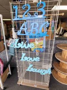 lot 763 image: WIRE DISPLAY UNIT MOUNTED ON WHEELED BASE AS SHOWN.