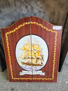 lot 775 image: VINTAGE WOOD CABINET FOR DARTBOARD WITH CLIPPER SHIP DESIGN AS SHOWN.