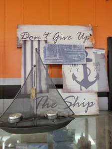 lot 850 image: WALL DECOR AND SAILBOAT TEALIGHT HOLDER AS SHOWN.