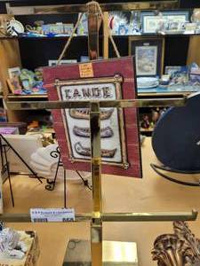 lot 868 image: GOLD TONE DISPLAY UNIT WITH PLAQUE AS SHOWN.