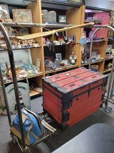 lot 886 image: METAL CLOTHING RACK ON WHEELS WITH MESH-STYLE BASE AS SHOWN. CONTENTS SHOWN NOT INCLUDED