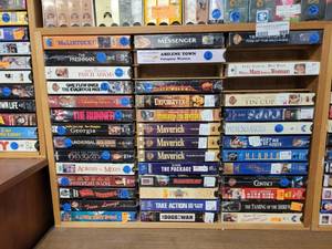 lot 999 image: LOT OF ASSORTED VHS MOVIES IN WOODEN DISPLAY AS SHOWN.