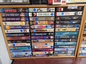 lot 1006 image: LOT OF ASSORTED VHS MOVIES IN WOODEN DISPLAY AS SHOWN.