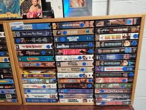 lot 1007 image: LOT OF ASSORTED VHS MOVIES IN WOODEN DISPLAY AS SHOWN.