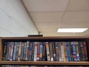 lot 1011 image: LOT OF ASSORTED VHS MOVIES FROM TOP SHELF ONLY AS SHOWN.