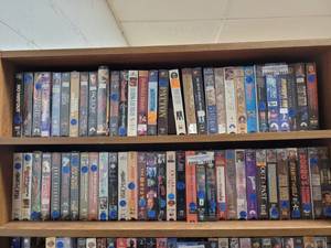 lot 1012 image: LOT OF ASSORTED VHS MOVIES ON SECOND FROM TOP SHELF ONLY AS SHOWN.