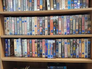 lot 1013 image: LOT OF ASSORTED VHS MOVIES ON THIRD SHELF ONLY AS SHOWN.