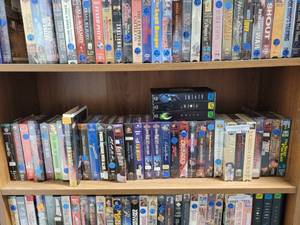 lot 1014 image: LOT OF ASSORTED VHS MOVIES ON FOURTH SHELF ONLY AS SHOWN.