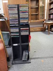lot 1053 image: CD HOLDER STAND WITH ASSORTED CDS AS SHOWN.