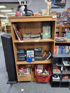 lot 1054 image: CONTENTS OF SHELF ROMAN SCULPTURE, MARILYN MONROE PLANNER, MOVIE CASES, CASSETTE TAPES AND MORE AS SHOWN. SHELF NOT INCLUDED