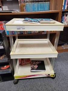 lot 1057 image: 3-TIER PLASTIC CART ON WHEELS WITH CONTENTS SHOWN.