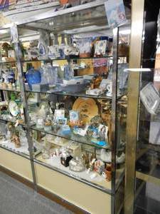 lot 892 image: METAL FRAME WITH GLASS SHELVES DISPLAY UNIT AS SHOWN. CONTENTS SHOWN NOT INCLUDED (DELAYED PICK UP BETWEEN 200 PM AND 400 PM)