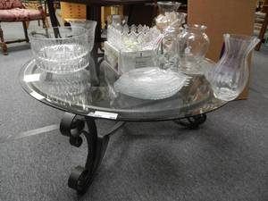 lot 906 image: ROUND WROUGHT IRON FRAME COFFEE TABLE WITH GLASS TOP IN STYLE SHOWN. CONTENTS NOT INCLUDED (DELAYED PICK UP BETWEEN 200 PM AND 400 PM)