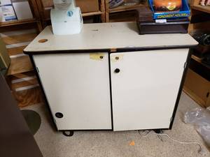 lot 950 image: CABINET  WORK TABLE ON CASTERS AS SHOWN. CONTENTS NOT INCLUDED.