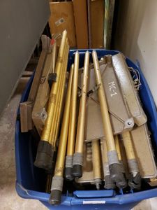 lot 1247 image: PLASTIC TUB FULL OF DISASSEMBLED VINTAGE PROJECTOR STANDS AS SHOWN.