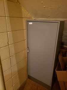 lot 1455 image: WOOD STORAGE SHELF WITH LOCKABLE DOORKEY.